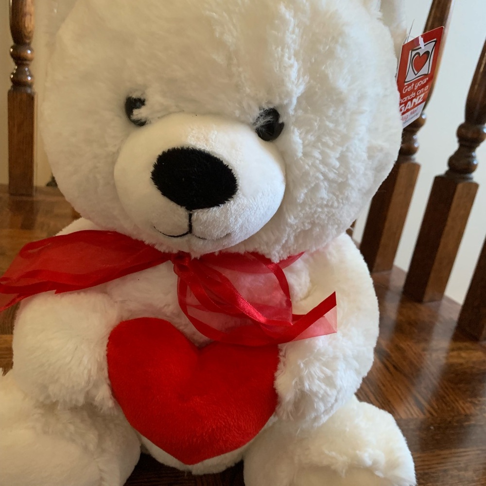 white bear holding heart